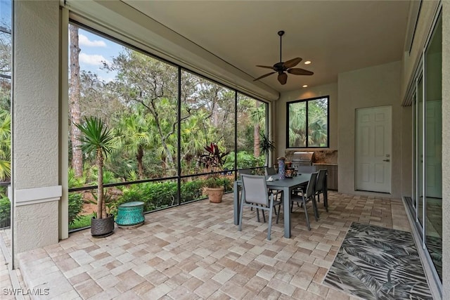 sunroom featuring ceiling fan