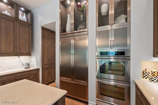 kitchen featuring stainless steel appliances and tasteful backsplash