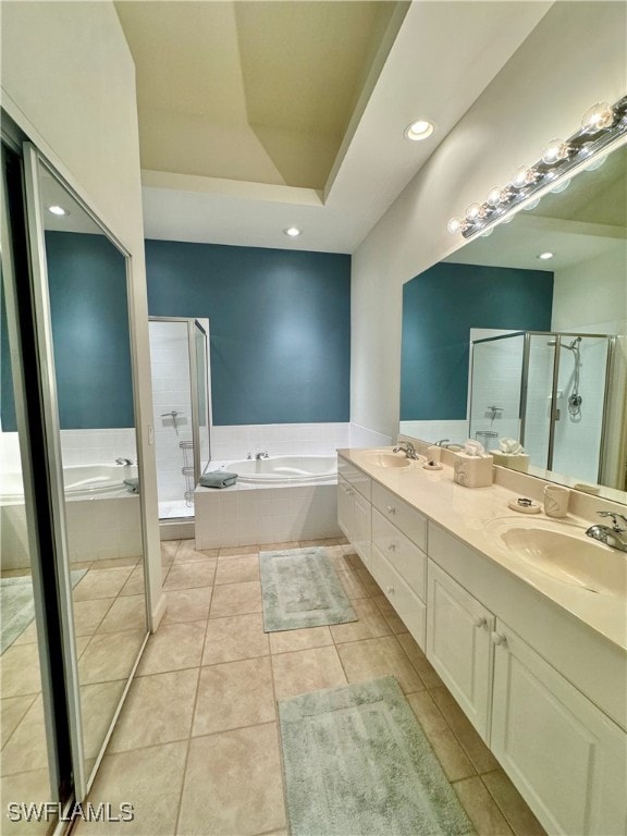 bathroom with tile patterned flooring, vanity, and separate shower and tub