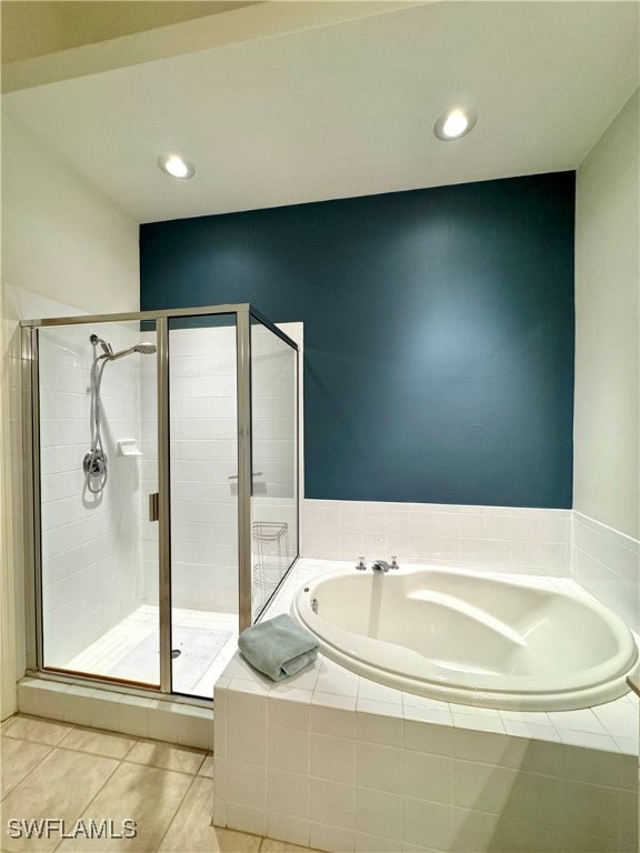 bathroom featuring tile patterned floors and separate shower and tub