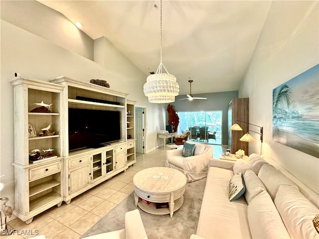 tiled living room featuring ceiling fan with notable chandelier and high vaulted ceiling