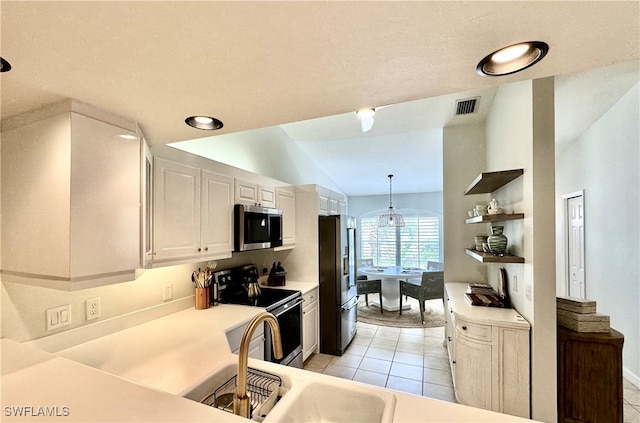 kitchen featuring white cabinetry, stainless steel appliances, pendant lighting, vaulted ceiling, and light tile patterned floors