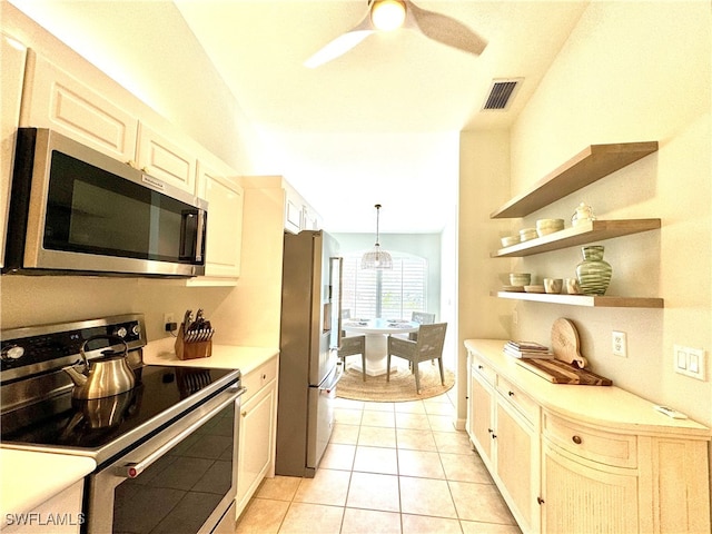 kitchen featuring pendant lighting, ceiling fan, light tile patterned floors, and appliances with stainless steel finishes