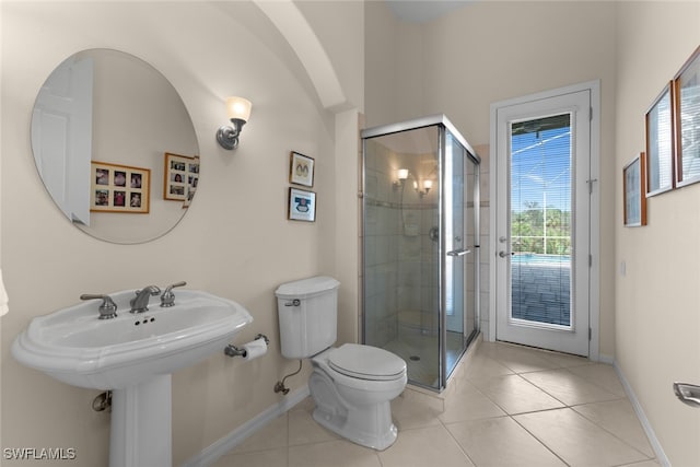 bathroom with tile patterned floors, a shower with door, and toilet