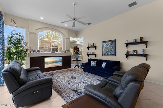 tiled living room with ceiling fan