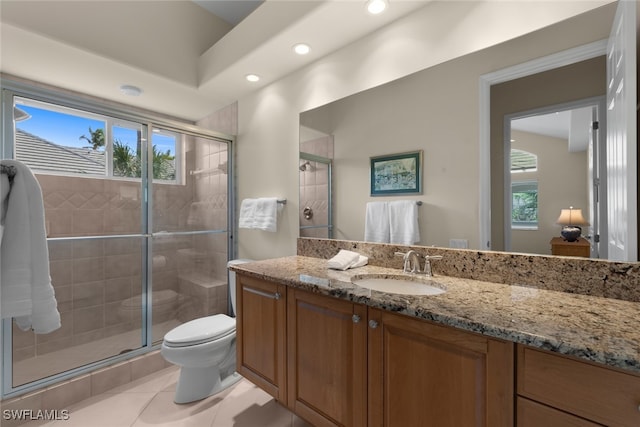 bathroom featuring tile patterned floors, plenty of natural light, vanity, and toilet