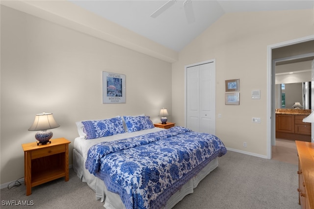 bedroom featuring ceiling fan, a closet, light carpet, and lofted ceiling