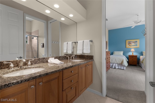 bathroom with tile patterned floors, ceiling fan, an enclosed shower, and vanity