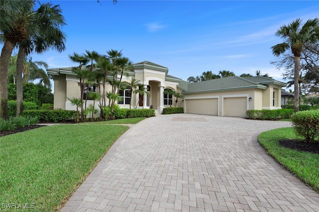 view of front of house with a front yard and a garage