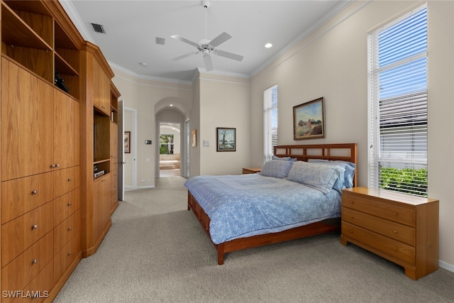 bedroom featuring ceiling fan, crown molding, and light colored carpet