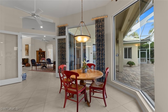 tiled dining area with ceiling fan and french doors