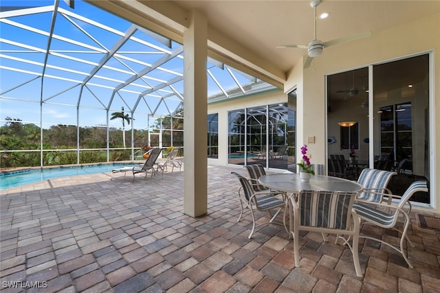 view of patio with ceiling fan and a lanai