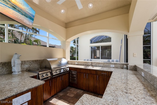 view of patio with area for grilling, sink, and exterior kitchen