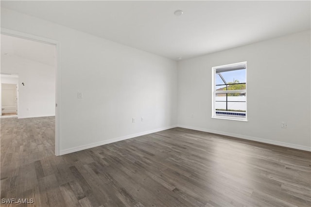 spare room with dark hardwood / wood-style flooring