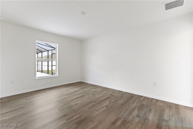 unfurnished room with hardwood / wood-style flooring