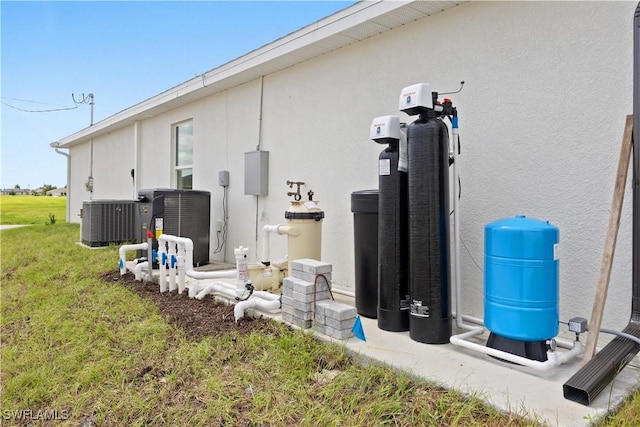 view of property exterior featuring cooling unit and a lawn