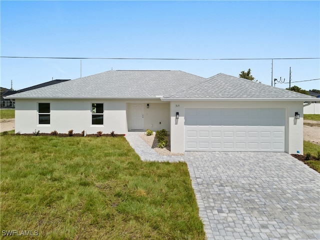 ranch-style home with a garage and a front lawn