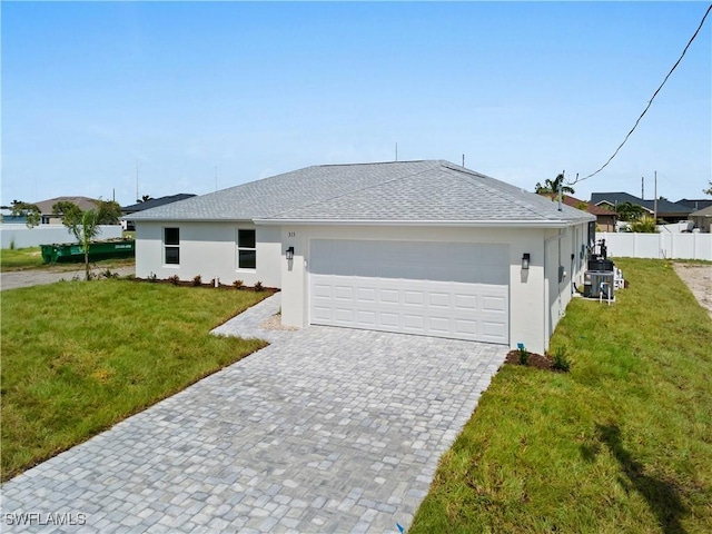 single story home featuring a garage and a front yard