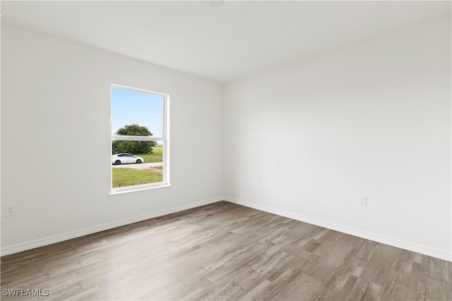 unfurnished room with light wood-type flooring