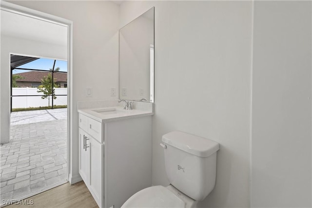 bathroom featuring vanity, toilet, and hardwood / wood-style floors