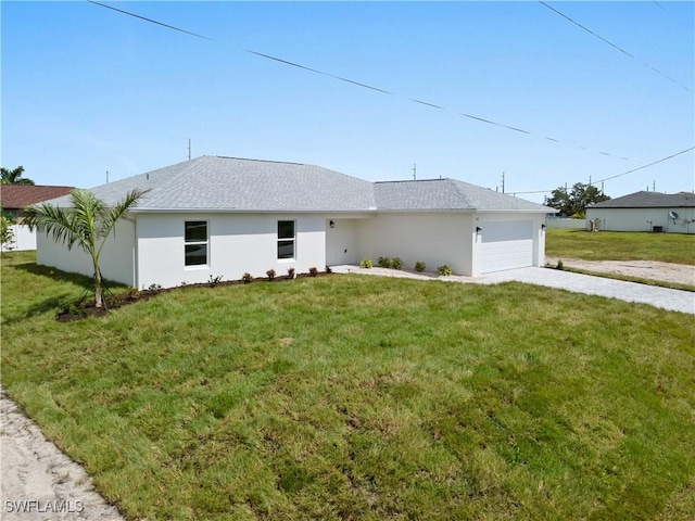 exterior space featuring a garage and a yard