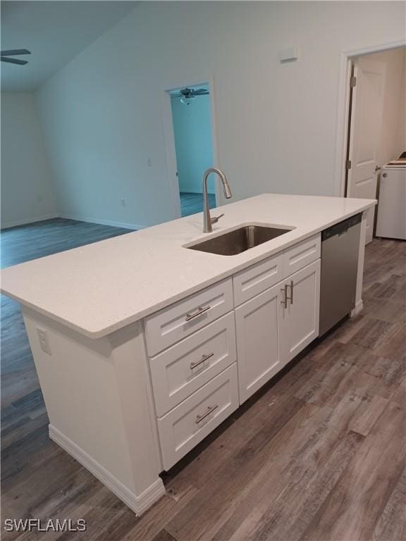 kitchen with washer / clothes dryer, dishwasher, an island with sink, sink, and white cabinets