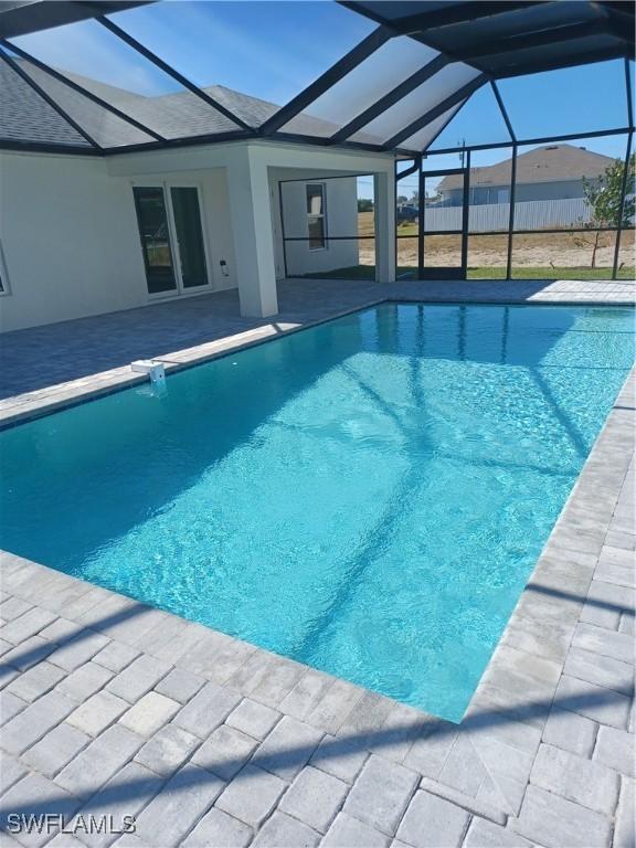 view of pool featuring a patio and glass enclosure