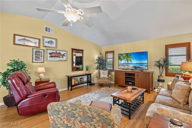 living room with light hardwood / wood-style flooring, ceiling fan, and vaulted ceiling