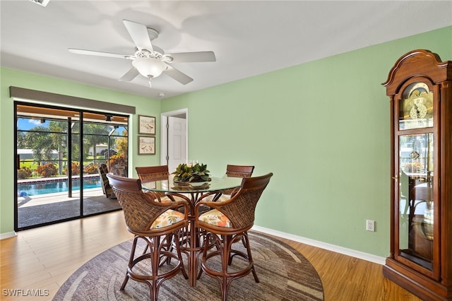 dining area with ceiling fan and light wood-type flooring