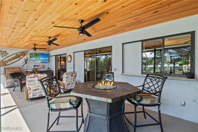 view of patio featuring ceiling fan and an outdoor fire pit