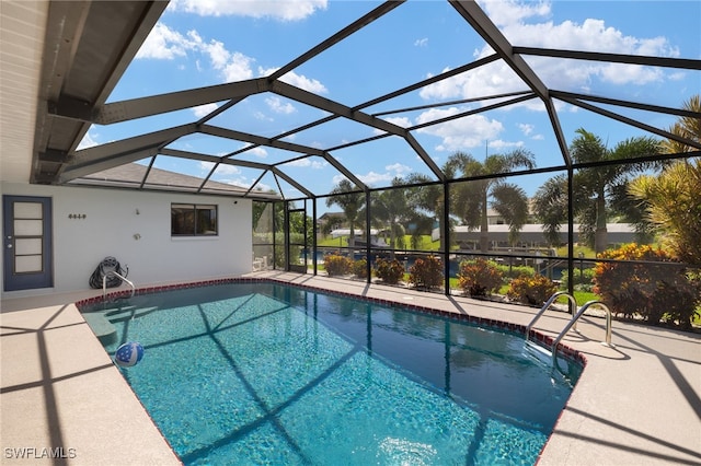 view of swimming pool featuring a patio area and glass enclosure