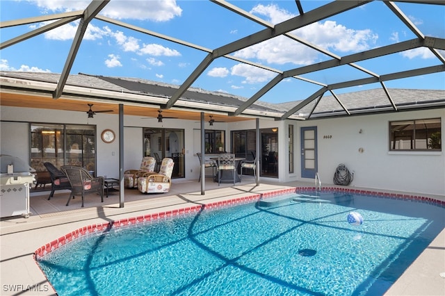 view of pool with a lanai, a patio area, and ceiling fan