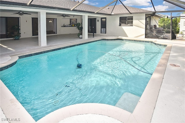 view of pool with a lanai, ceiling fan, and a patio