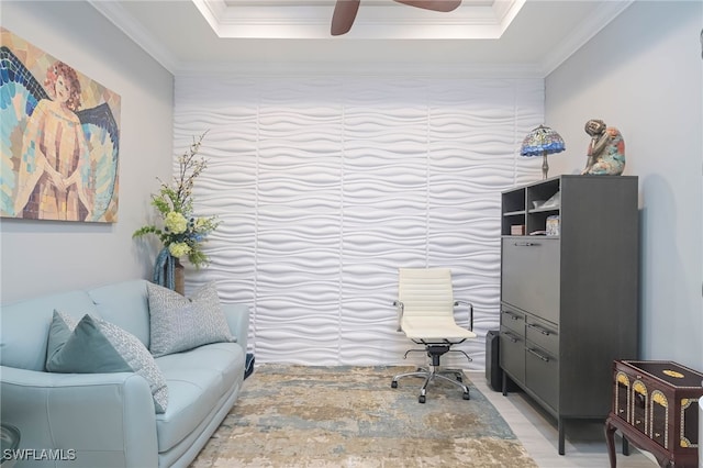 office space with ceiling fan, ornamental molding, and a tray ceiling