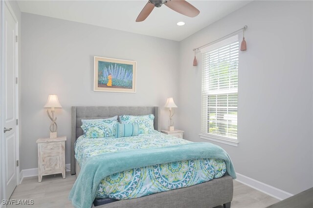 bedroom with light hardwood / wood-style flooring and ceiling fan