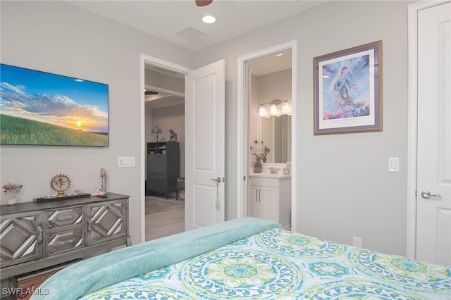 bedroom with connected bathroom and sink