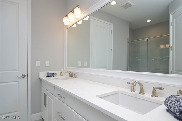 bathroom featuring vanity and an enclosed shower