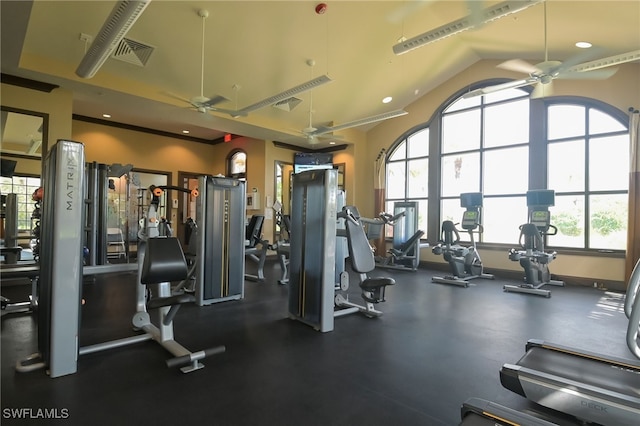 gym with lofted ceiling, ceiling fan, and plenty of natural light