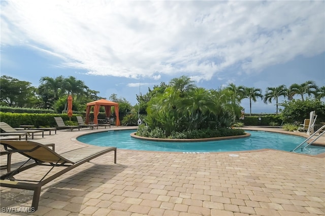 view of swimming pool with a patio area