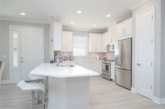 kitchen with light hardwood / wood-style flooring, white cabinetry, stainless steel appliances, and sink