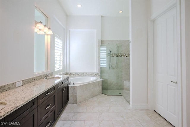 bathroom featuring vanity and separate shower and tub