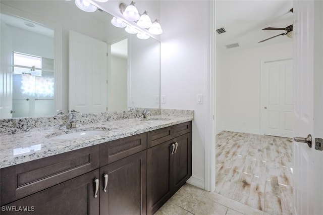 bathroom featuring ceiling fan and vanity