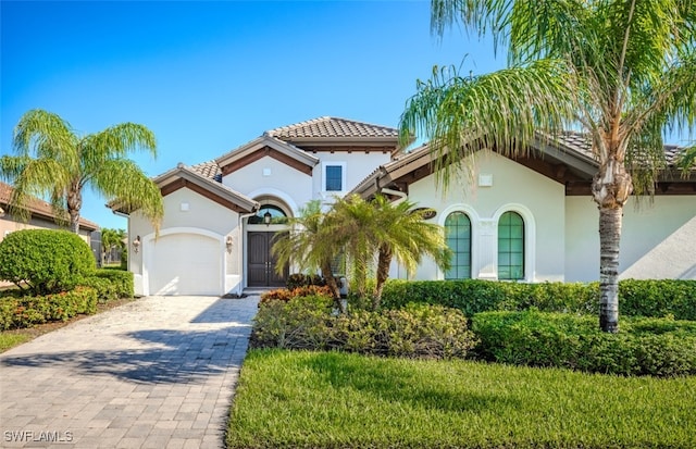 mediterranean / spanish-style home with a garage