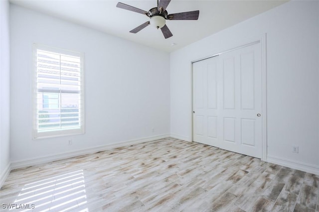 unfurnished bedroom with a closet, ceiling fan, and light hardwood / wood-style flooring