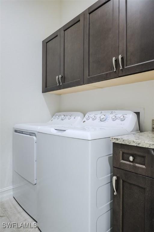 laundry room featuring cabinets and separate washer and dryer