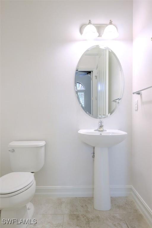 bathroom with tile patterned flooring and toilet