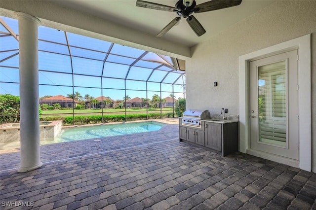 view of swimming pool featuring a grill, area for grilling, sink, and glass enclosure