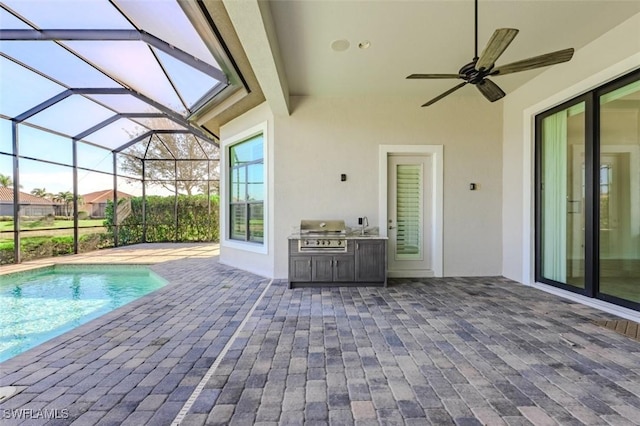 view of pool with a grill, a patio area, and exterior kitchen