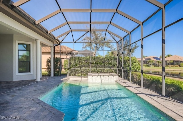 view of pool featuring a hot tub, a patio, and a lanai