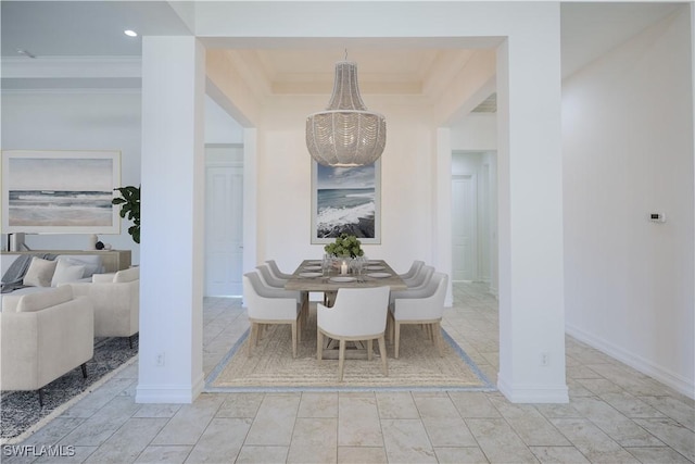 dining area featuring an inviting chandelier and ornamental molding